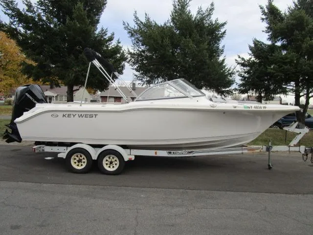 Slide: The Image of 2022 Key West 239 DFS boat on trailer, parked outdoors. - 8