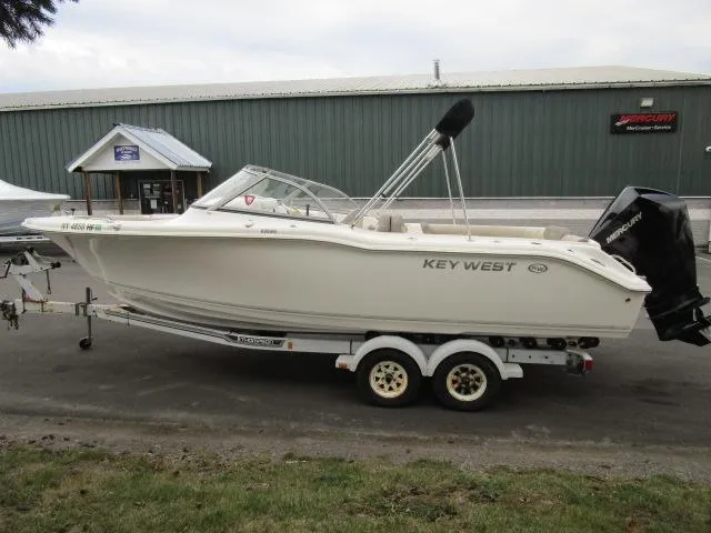 Slide: The Image of 2022 Key West 239 DFS boat on trailer, parked outside a building. - 9