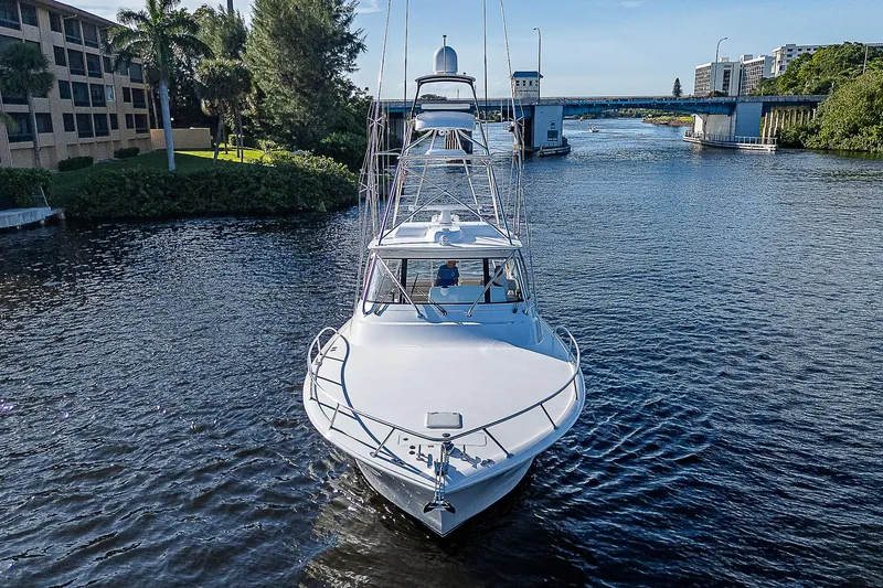 Slide: The Image of 2023 Viking 54 Open yacht cruising on a scenic waterway. - 10