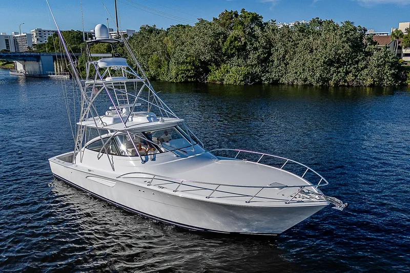 Slide: The Image of 2023 Viking 54 Open yacht cruising on a serene river. - 11