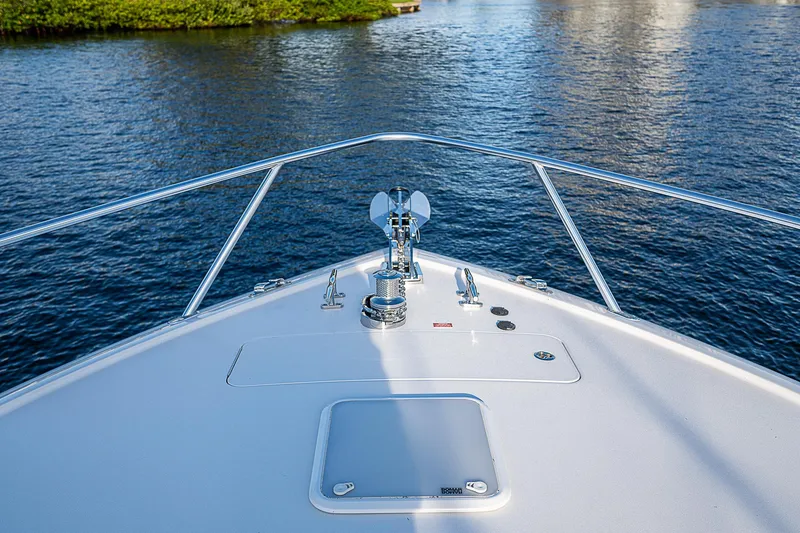 Slide: The Image of Bow view of 2023 Viking 54 Open yacht on calm water. - 14