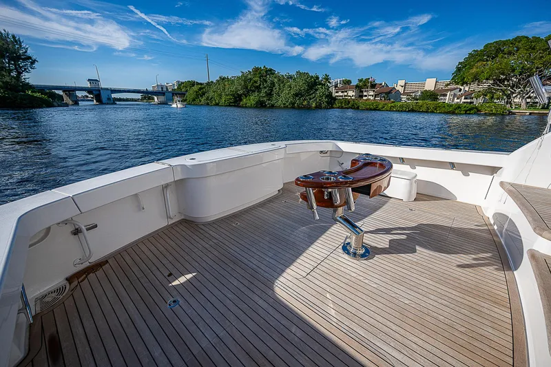 Slide: The Image of 2023 Viking 54 Open yacht deck with scenic waterfront view. - 19