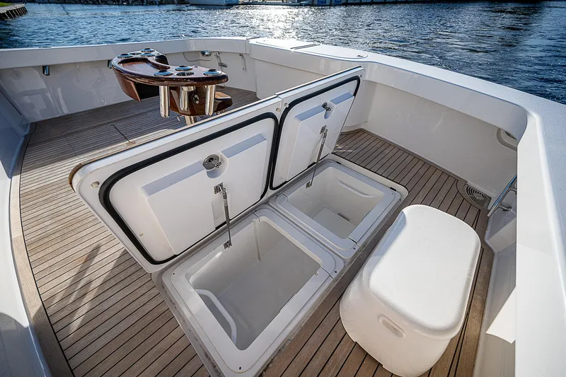 Slide: The Image of 2023 Viking 54 Open yacht deck with storage compartments and seating. - 24
