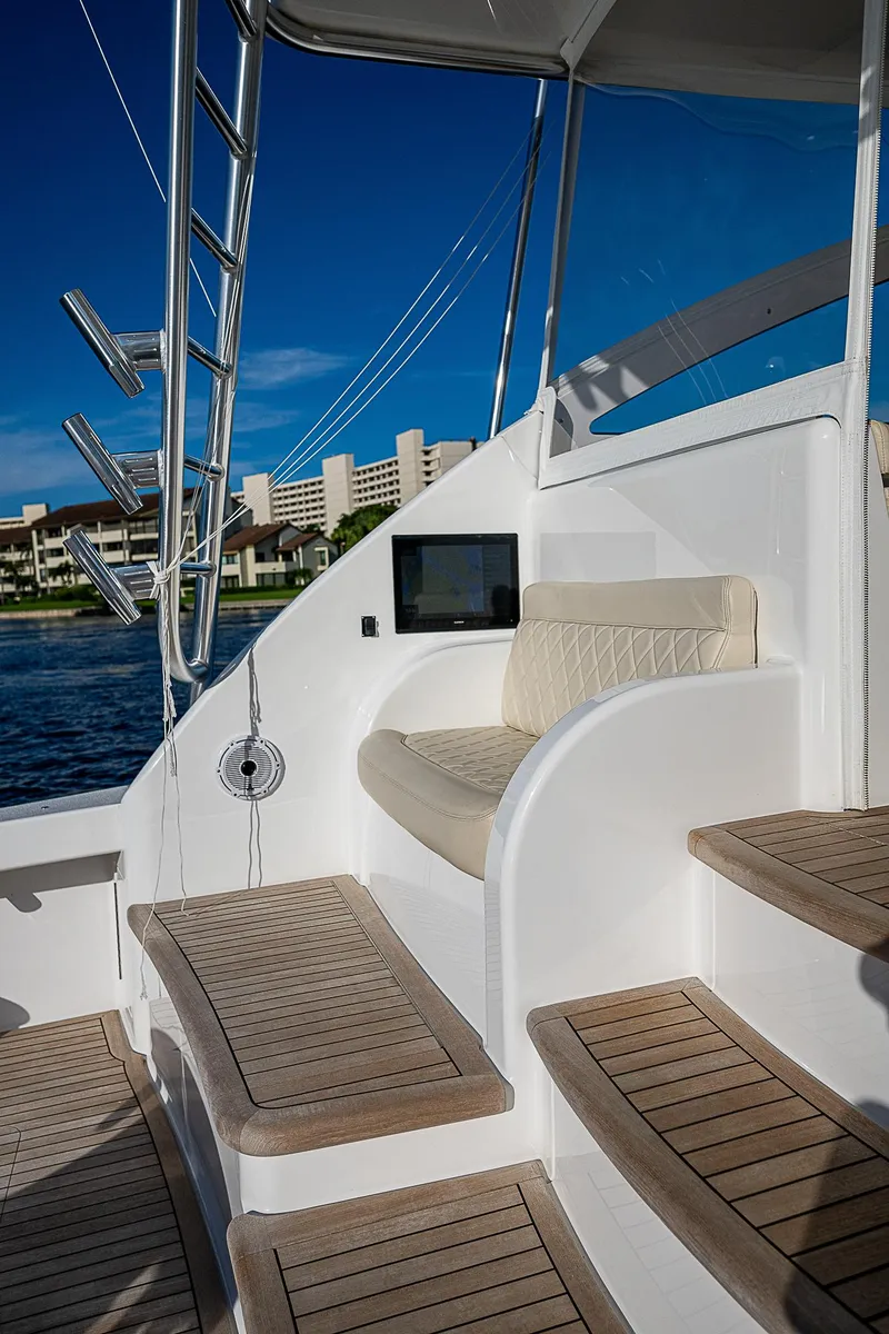 Slide: The Image of 2023 Viking 54 Open yacht with elegant seating and teak steps. - 26