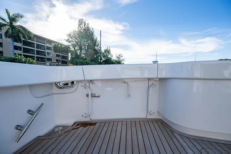 Slide: The Image of 2023 Viking 54 Open yacht deck with sleek design and wooden flooring. - 27