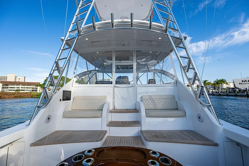 Slide: The Image of 2023 Viking 54 Open yacht with spacious deck and seating, docked by the water. - 28