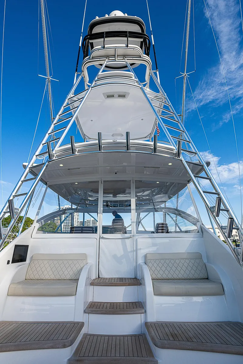 Slide: The Image of 2023 Viking 54 Open yacht with tower, luxurious seating, and clear blue sky. - 29
