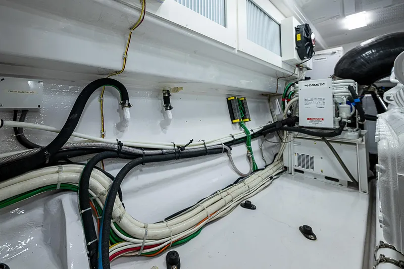 Slide: The Image of Engine room wiring of 2023 Viking 54 Open yacht, showcasing organized cables and equipment. - 39