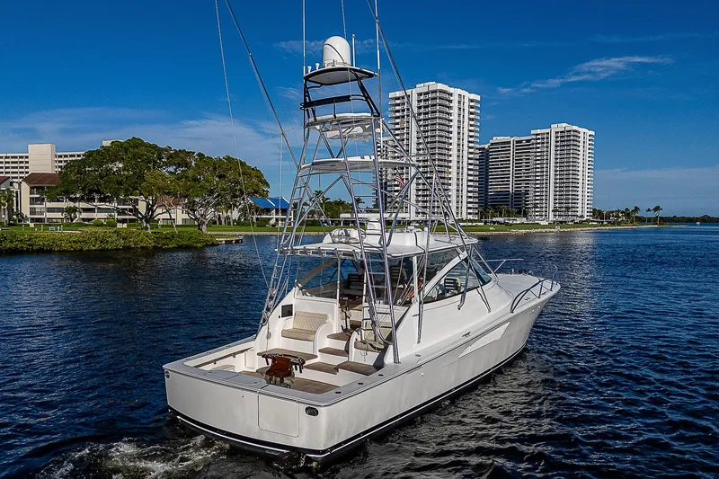 Slide: The Image of 2023 Viking 54 Open yacht cruising near waterfront skyscrapers. - 4