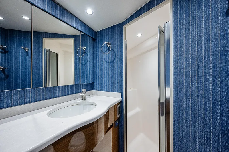 Slide: The Image of Luxurious bathroom in 2023 Viking 54 Open yacht with modern fixtures and blue decor. - 48