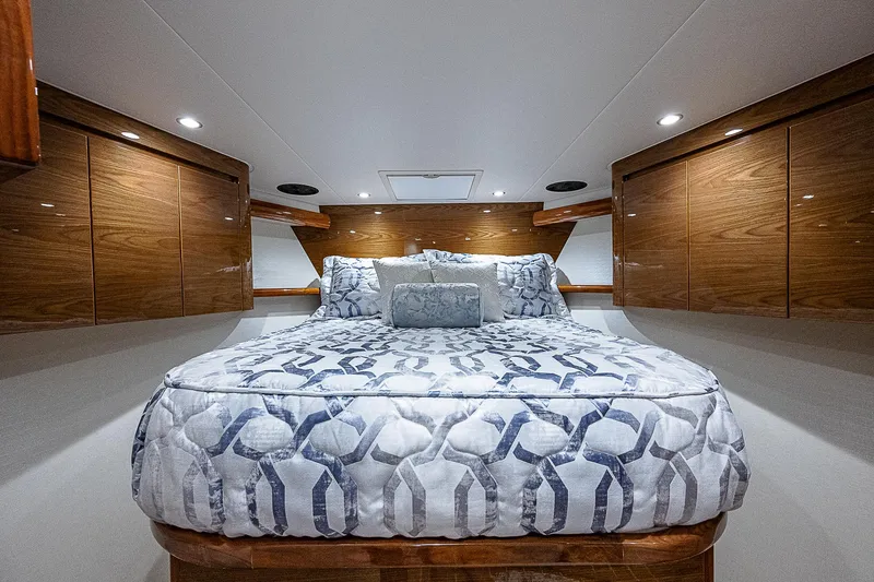 Slide: The Image of Luxurious bedroom interior of 2023 Viking 54 Open yacht with elegant wood cabinetry. - 49