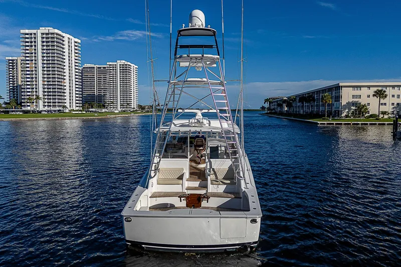 Slide: The Image of 2023 Viking 54 Open yacht cruising in a scenic waterfront setting. - 5