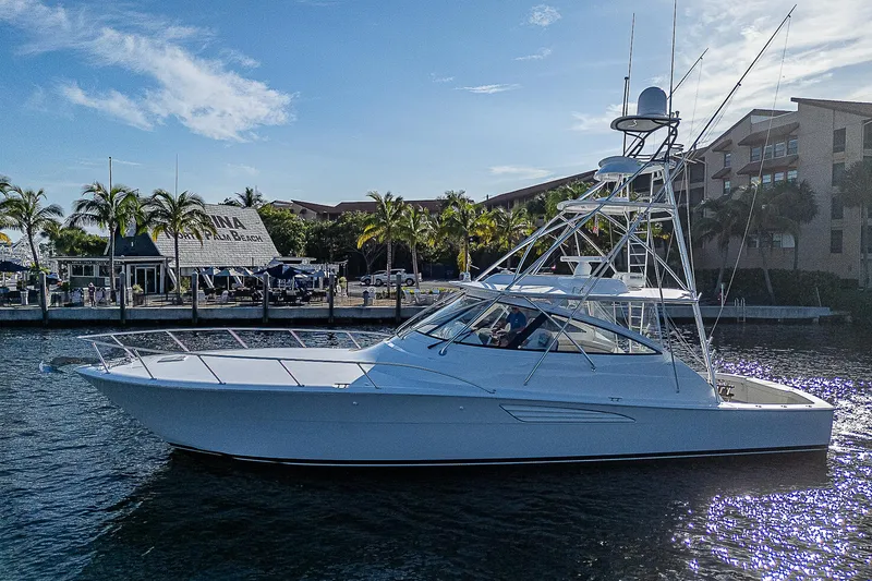 Slide: The Image of 2023 Viking 54 Open yacht cruising in a sunny marina. - 7