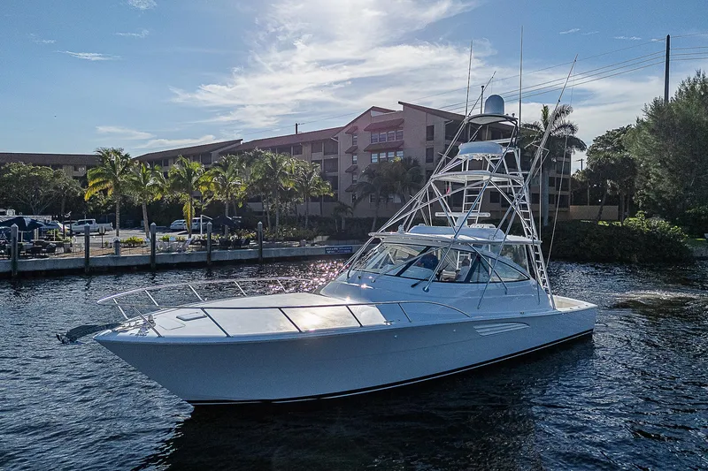 Slide: The Image of 2023 Viking 54 Open yacht cruising near a marina. - 8