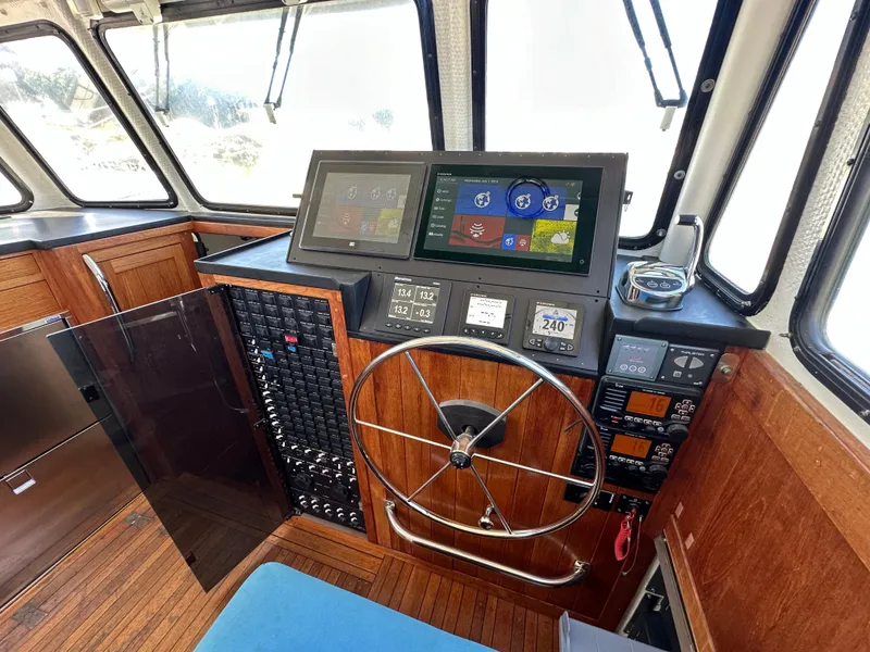 Slide: The Image of Interior of 1994 BHM Lobster Style CUSTOM boat with wood and blue seating. - 12