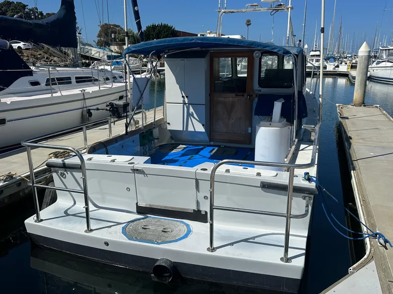 Slide: The Image of 1994 BHM Lobster Style CUSTOM boat docked near waterfront buildings under blue sky. - 3