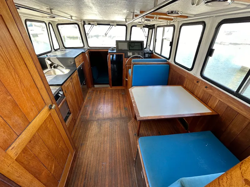 Slide: The Image of 1994 BHM Lobster Style CUSTOM boat docked at marina, clear sky, palm trees in background. - 5