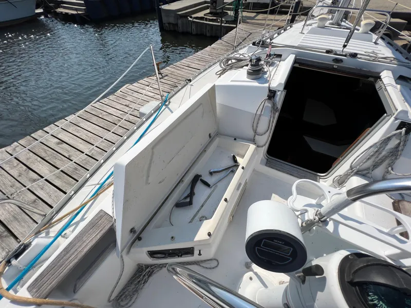 Slide: The Image of 1986 Hunter 31 sailboat cockpit with open storage, docked at marina. - 17