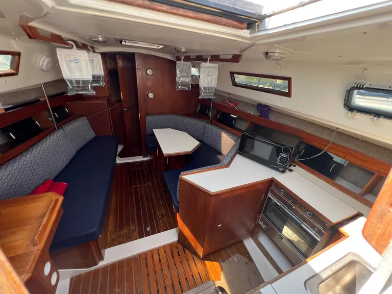 Slide: The Image of Interior of a 1986 Hunter 31 sailboat with wood finishes and seating area. - 20