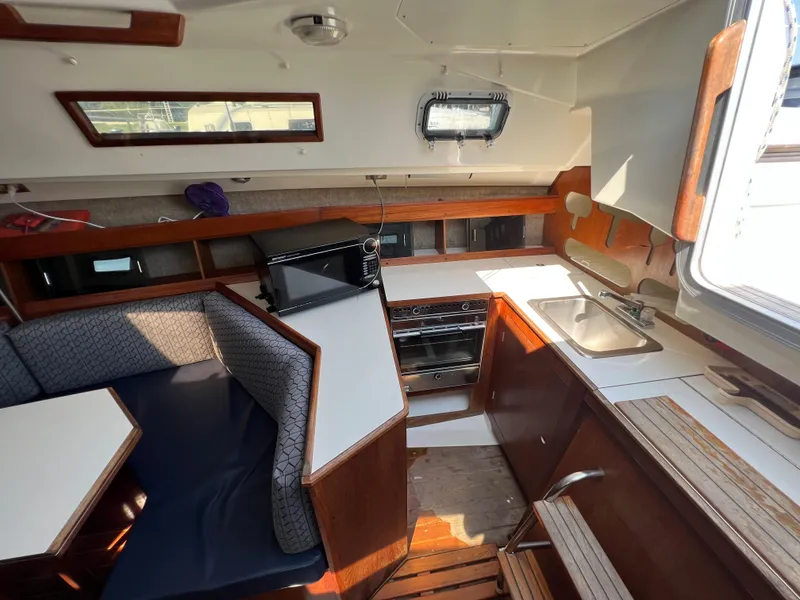 Slide: The Image of Interior of 1986 Hunter 31 sailboat with kitchen and dining area. - 22