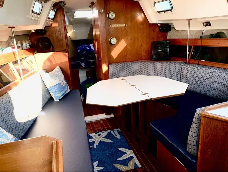 Slide: The Image of Interior of 1986 Hunter 31 sailboat with cozy seating and nautical decor. - 23