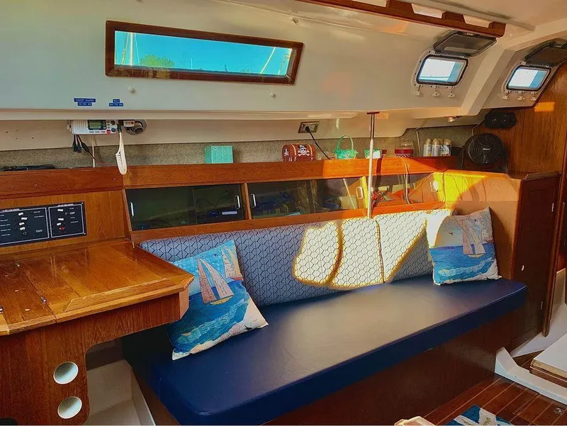 Slide: The Image of Interior of 1986 Hunter 31 sailboat with cozy seating and nautical decor. - 25