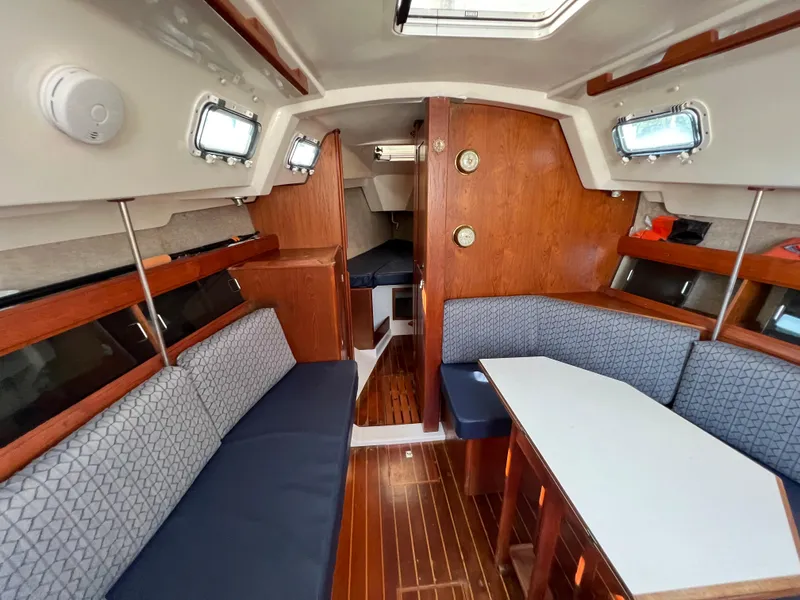 Slide: The Image of Interior of 1986 Hunter 31 sailboat with wood finish and blue seating. - 28