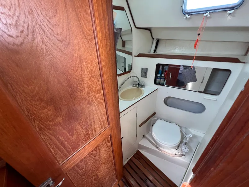 Slide: The Image of 1986 Hunter 31 sailboat bathroom with wooden accents and compact design. - 30