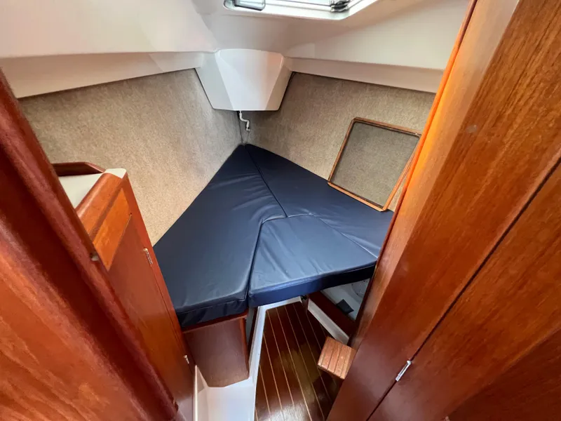Slide: The Image of Interior cabin of 1986 Hunter 31 sailboat with V-berth and wooden finishes. - 31