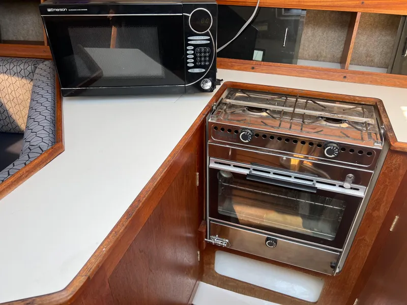 Slide: The Image of 1986 Hunter 31 yacht kitchen with microwave and stove. - 34