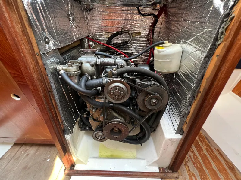 Slide: The Image of 1986 Hunter 31 engine compartment with visible components and insulation. - 37