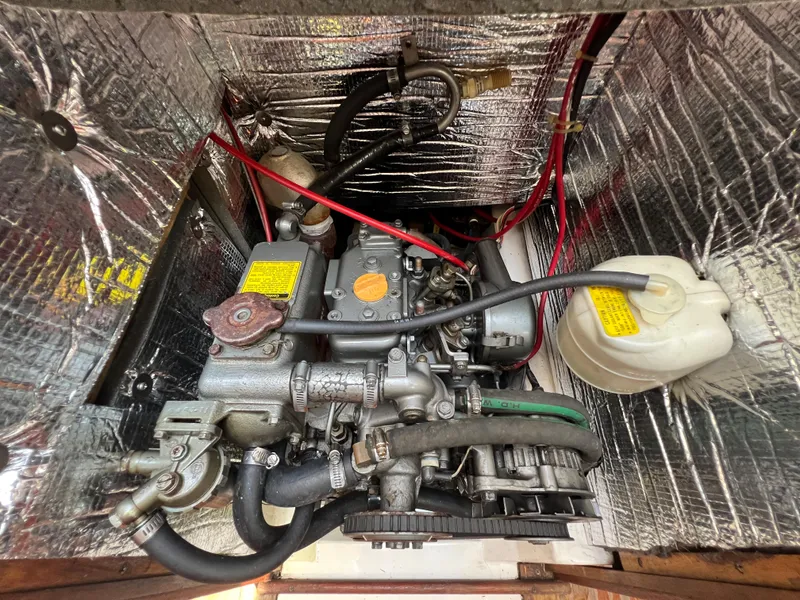 Slide: The Image of 1986 Hunter 31 engine compartment with visible wiring and components. - 38