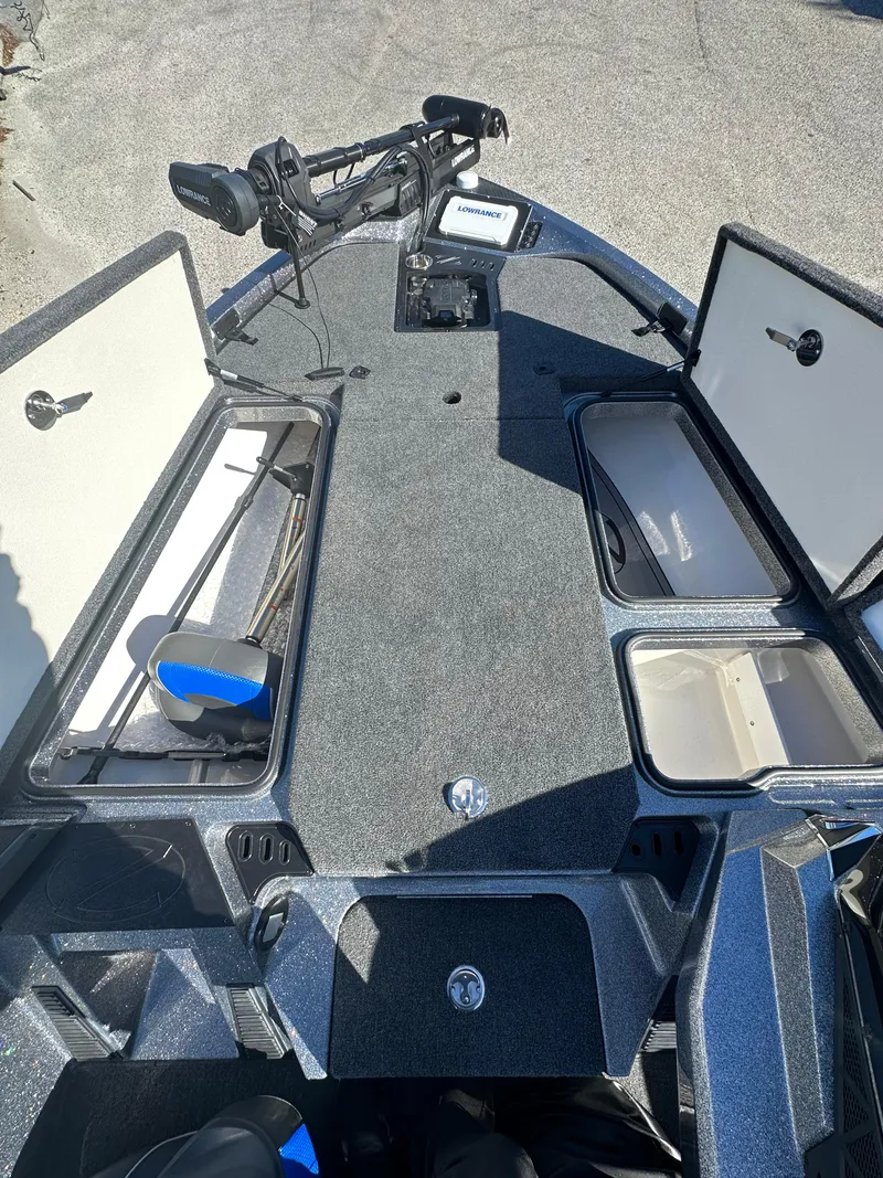 Slide: The Image of 2024 Ranger 518 Cup boat interior with open storage compartments. - 3