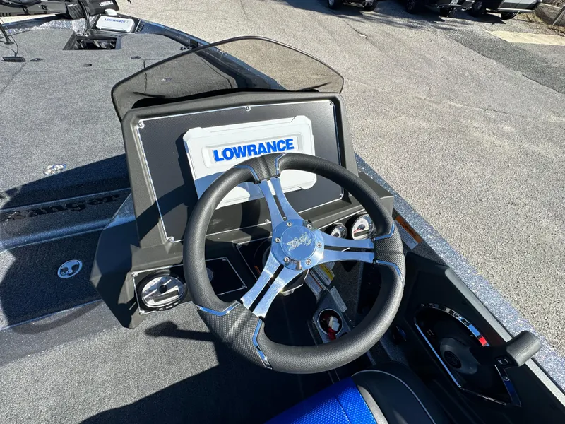 Slide: The Image of 2024 Ranger 518 Cup boat dashboard with Lowrance display and steering wheel. - 8