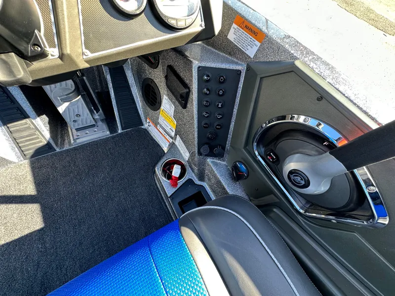 Slide: The Image of 2024 Ranger 518 Cup boat interior with control panel and blue seating. - 9