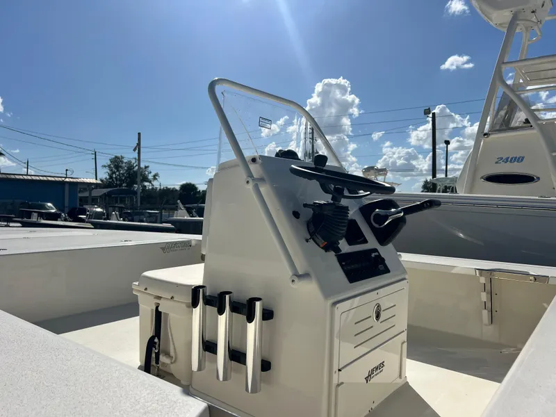 Slide: The Image of 2025 Hewes Redfisher 21 boat console under sunny sky. - 3
