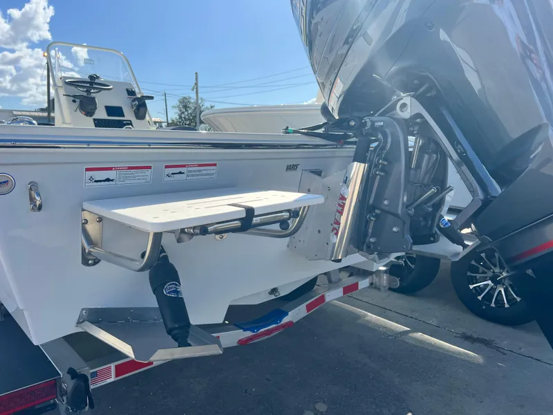 Slide: The Image of 2025 Hewes Redfisher 21 boat, rear view with motor and trailer. - 6