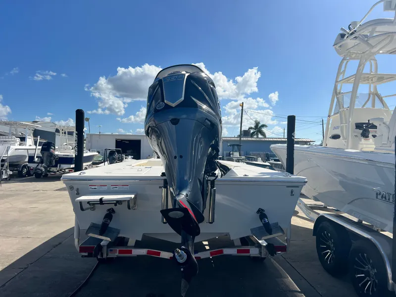 Slide: The Image of 2025 Hewes Redfisher 21 boat on trailer, sunny day, marina background. - 7