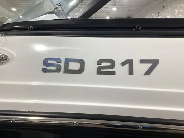 Slide: The Image of 2025 Hurricane SunDeck 217 OB boat side view with model number "SD 217". - 12