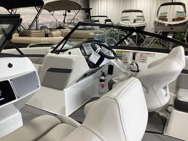 Slide: The Image of 2025 Hurricane SunDeck 217 OB boat interior with modern dashboard and seating. - 13
