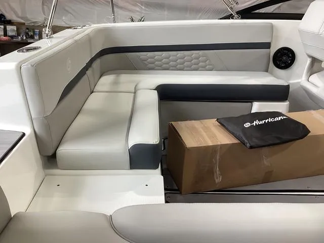 Slide: The Image of 2025 Hurricane SunDeck 217 OB boat interior with sleek seating and branded cover. - 4