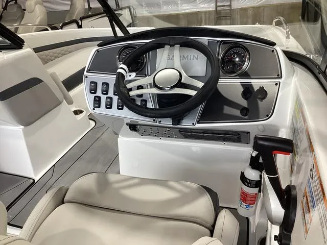 Slide: The Image of 2025 Hurricane SunDeck 217 OB boat dashboard with steering wheel and controls. - 5