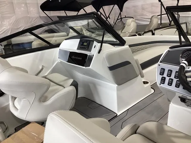 Slide: The Image of 2025 Hurricane SunDeck 217 OB boat interior with modern dashboard and seating. - 6