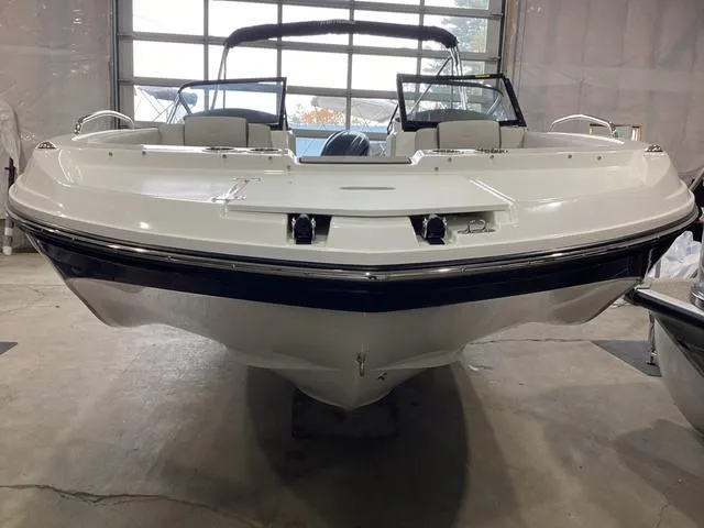 Slide: The Image of 2025 Hurricane SunDeck 217 OB boat in showroom, front view. - 8