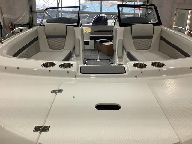 Slide: The Image of 2025 Hurricane SunDeck 217 OB boat interior with cushioned seating and cup holders. - 9