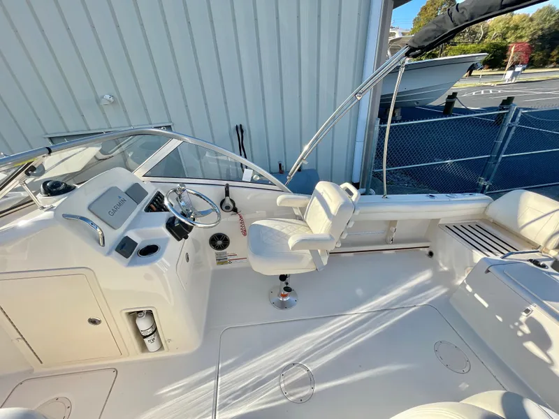 Slide: The Image of 2022 Grady-White Freedom 215 boat interior with steering wheel and seating. - 10