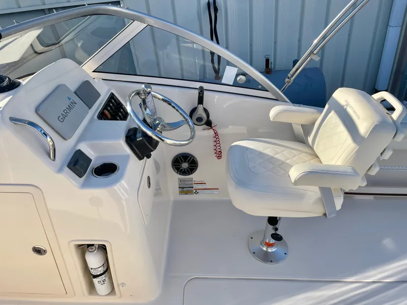 Slide: The Image of 2022 Grady-White Freedom 215 boat cockpit with steering wheel and captain's chair. - 11