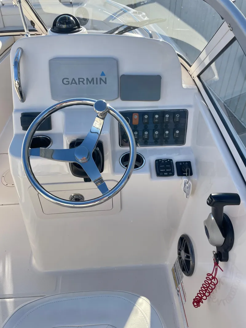 Slide: The Image of Grady-White Freedom 215 boat dashboard with Garmin navigation system, 2022 model. - 12