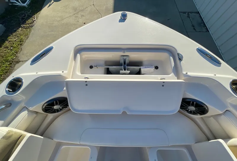 Slide: The Image of 2022 Grady-White Freedom 215 boat interior, featuring storage compartment and speakers. - 16