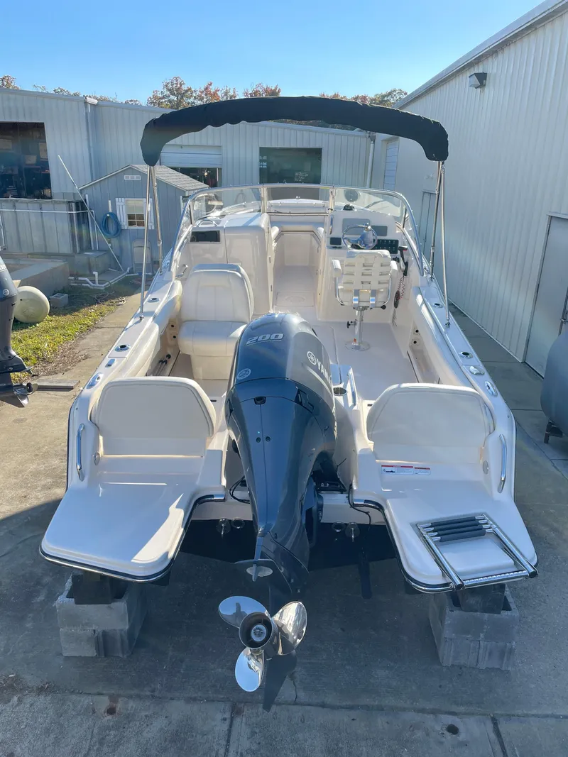 Slide: The Image of 2022 Grady-White Freedom 215 boat with outboard motor, docked outdoors. - 5